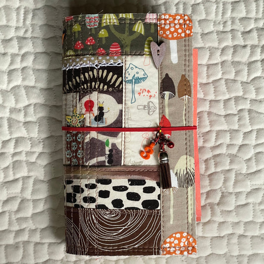 refillable watercolor journal with a quilted fabric cover in an ants go marching theme